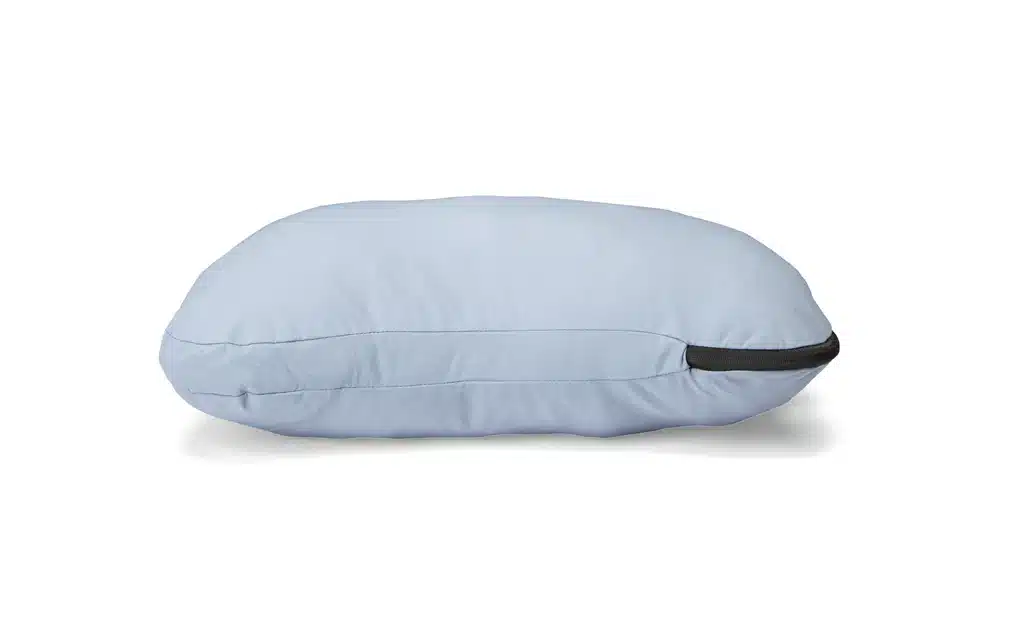 A side view of a grey HEST Pillow for Camping