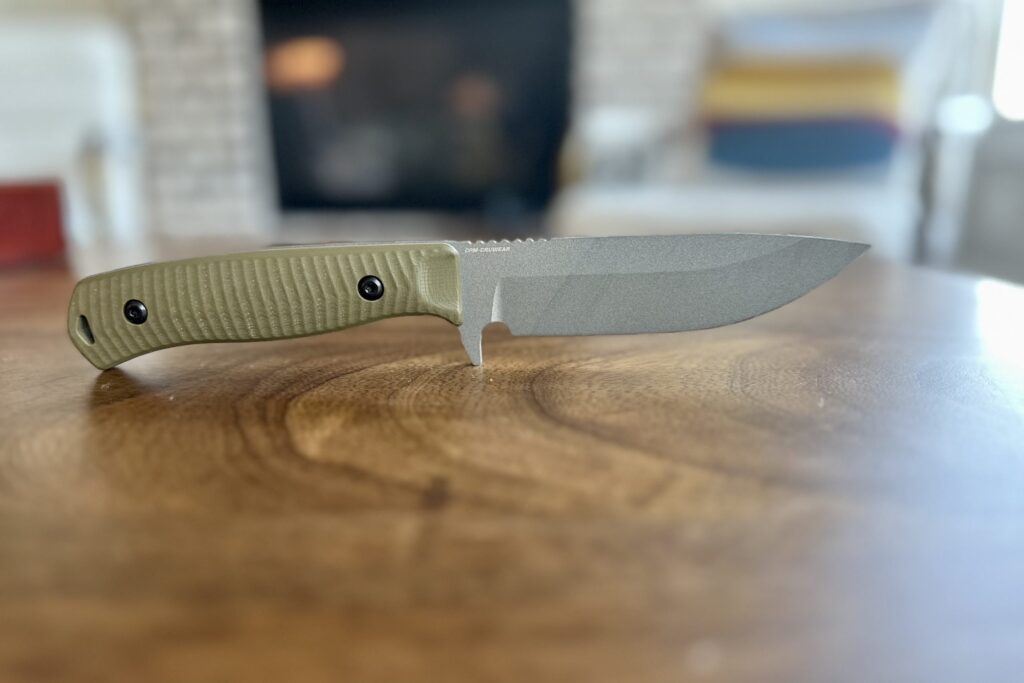 A view of a Benchmade Anominus knife on a wooden table