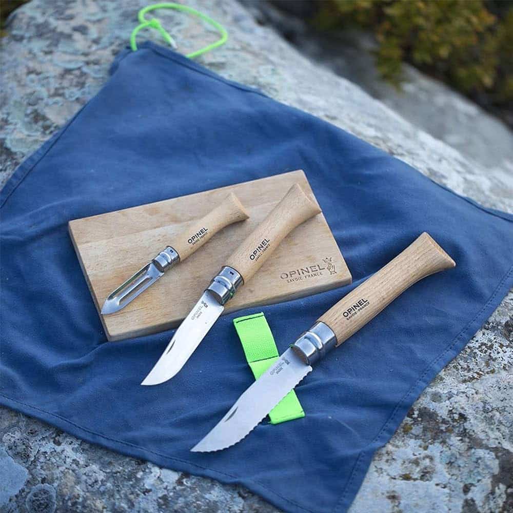 A view of a Opinel Nomad Cooking Kit placed on a blue cloth