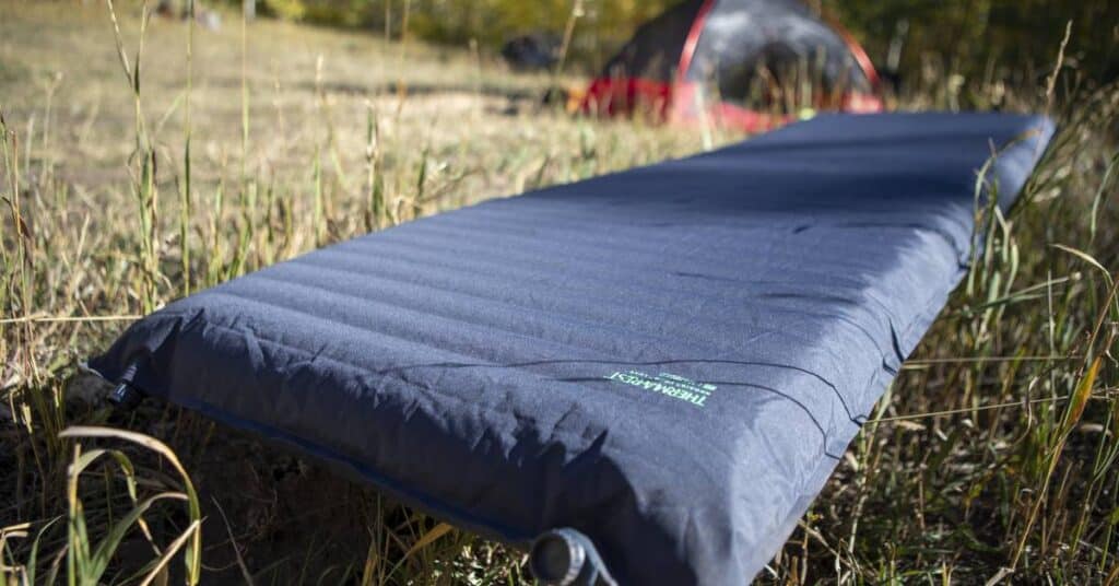 A view of a Therm a Rest NeoAir Topo Luxe Air Mattress laid in the grass