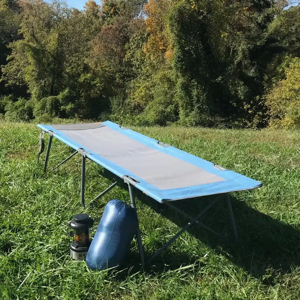 A view of a camping cot placed inside the grass