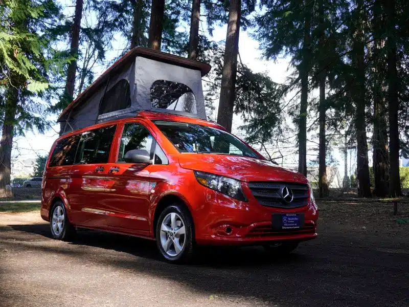 A view of a red caravan outfitter on road