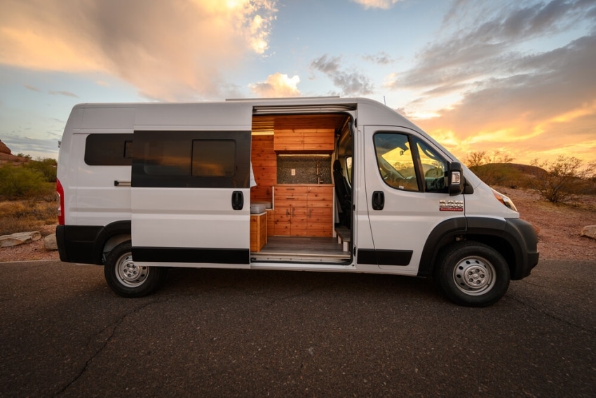 A view of a white boho camper van with its door opened