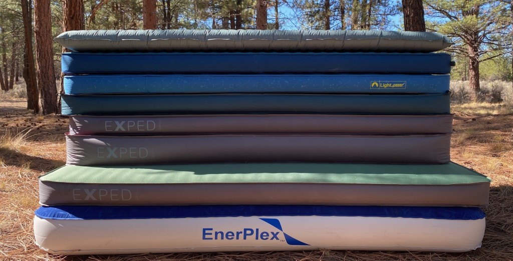 A view of air mattresses for camping piled up over each other