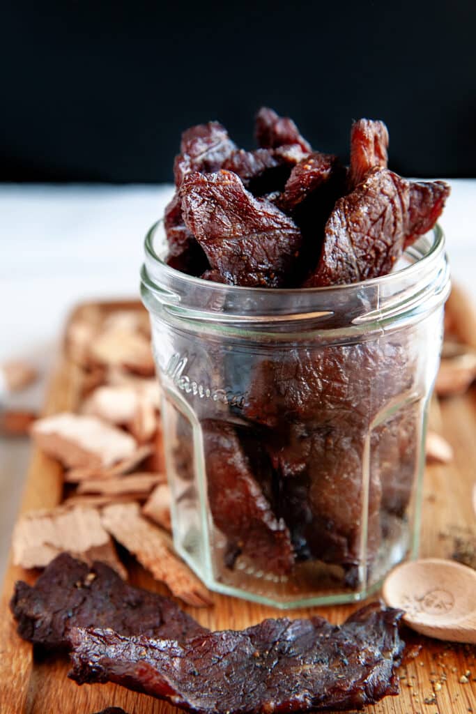 A view of beef jerky inisde a mason glass jar