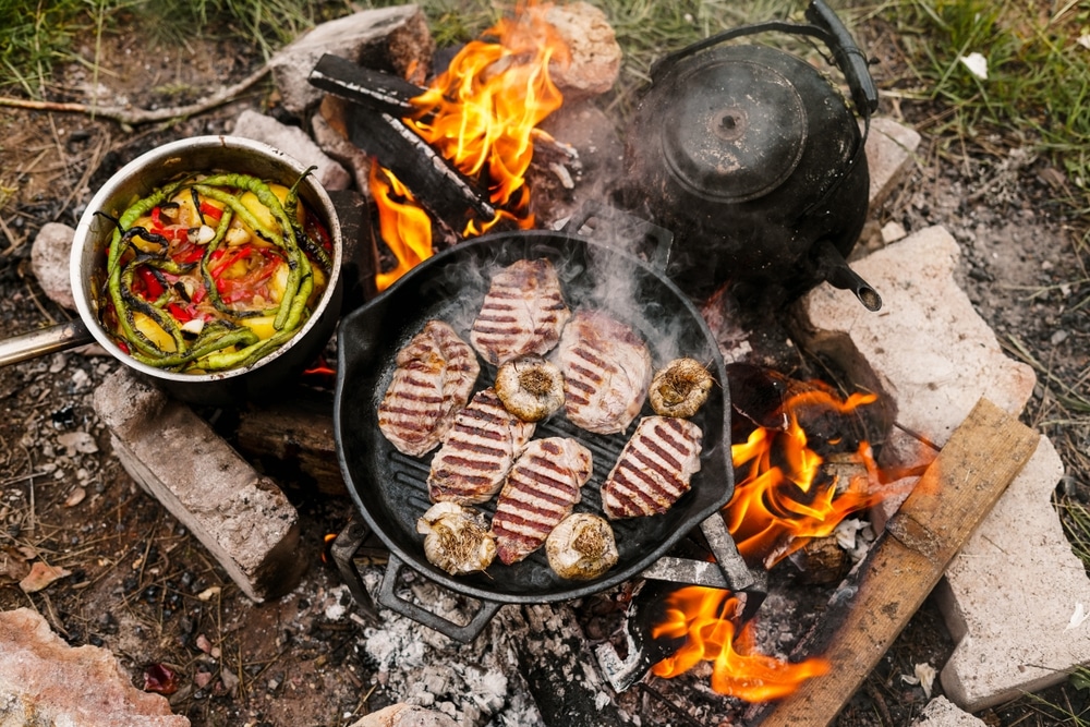 Campfire Red Meat In Pan Near The Fire Outdoors Bushcraft