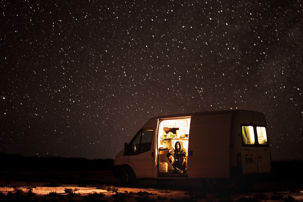 a person gazing The Stars In A Camper Van