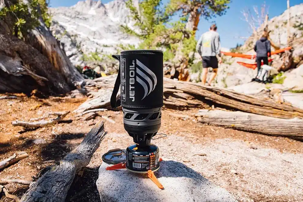 jetboil stove on a rock blurred view of campers