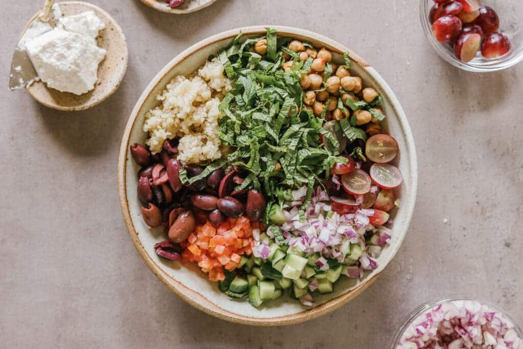 mediterranean bowl with chickpeas spanich tomatoes beans onions cucumber