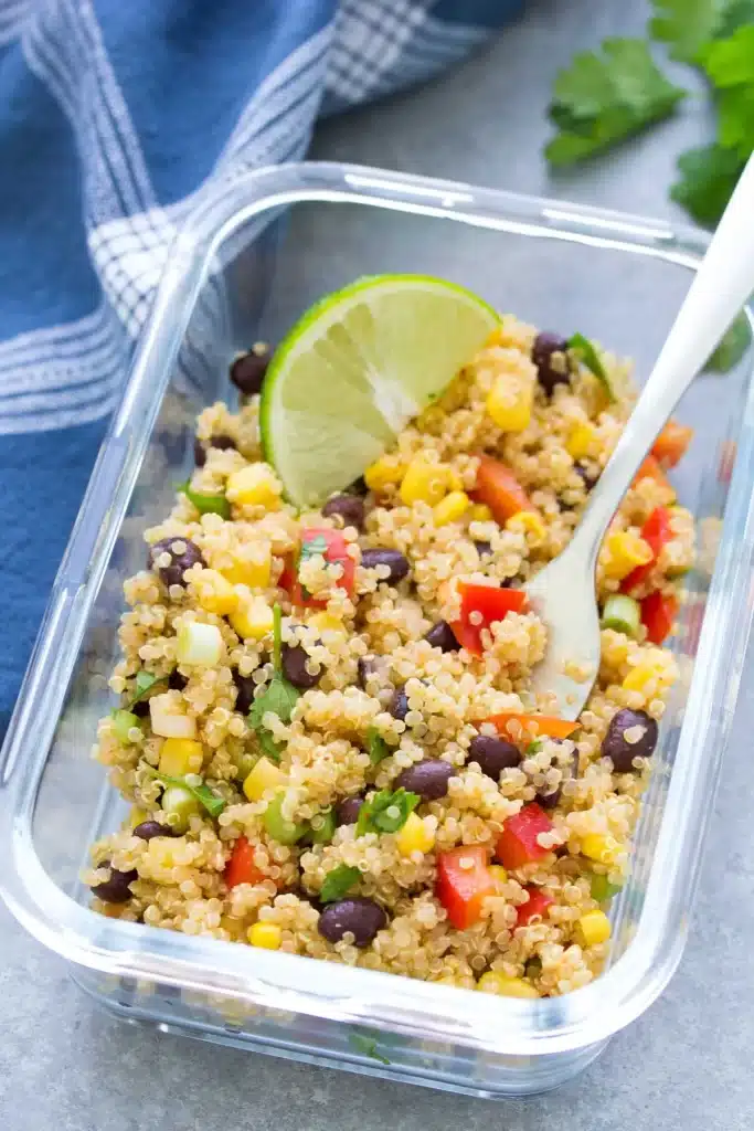 quinoa salad in a plastic bowl with spoon