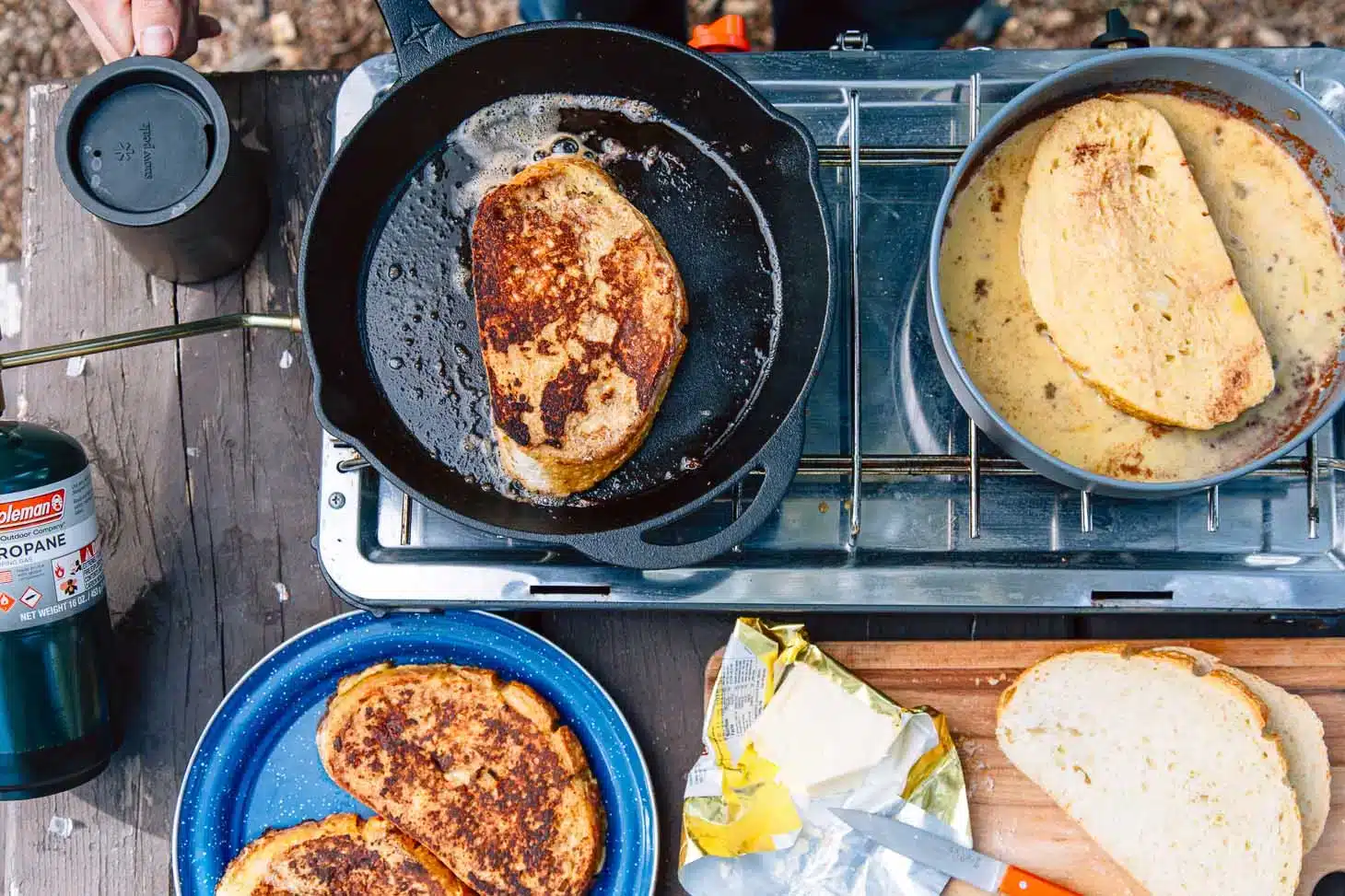 a french toast in skillet over stove toasts in plate