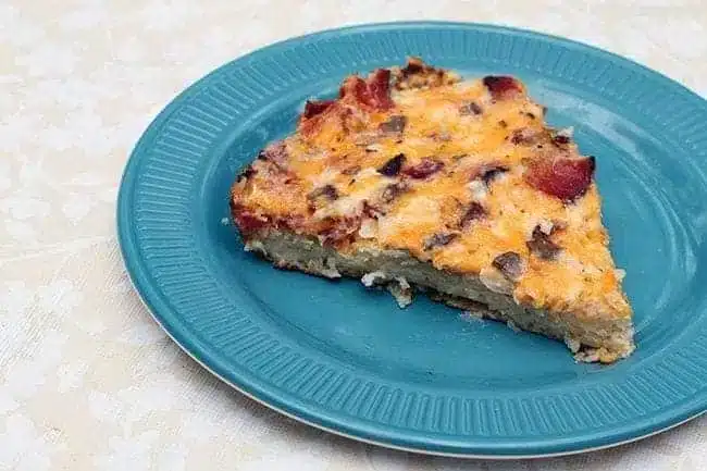 breakfast pizza slice in a blue plate