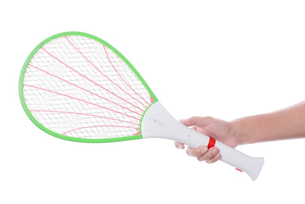 Hand holding electric shock device swat racket or mosquito zapper, pest killer machine with guide light on white background