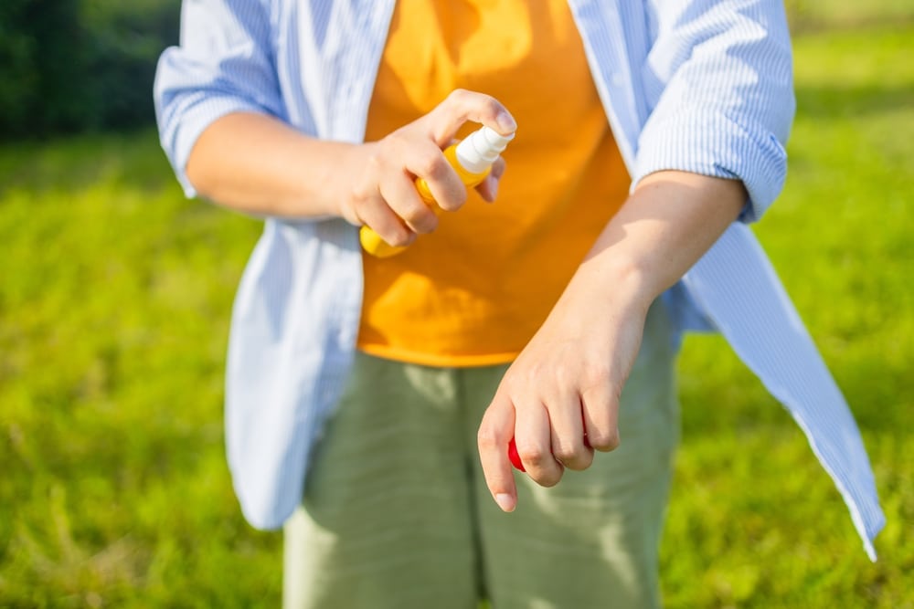 Mosquito Repellent Woman Using Insect Repellent Spray 